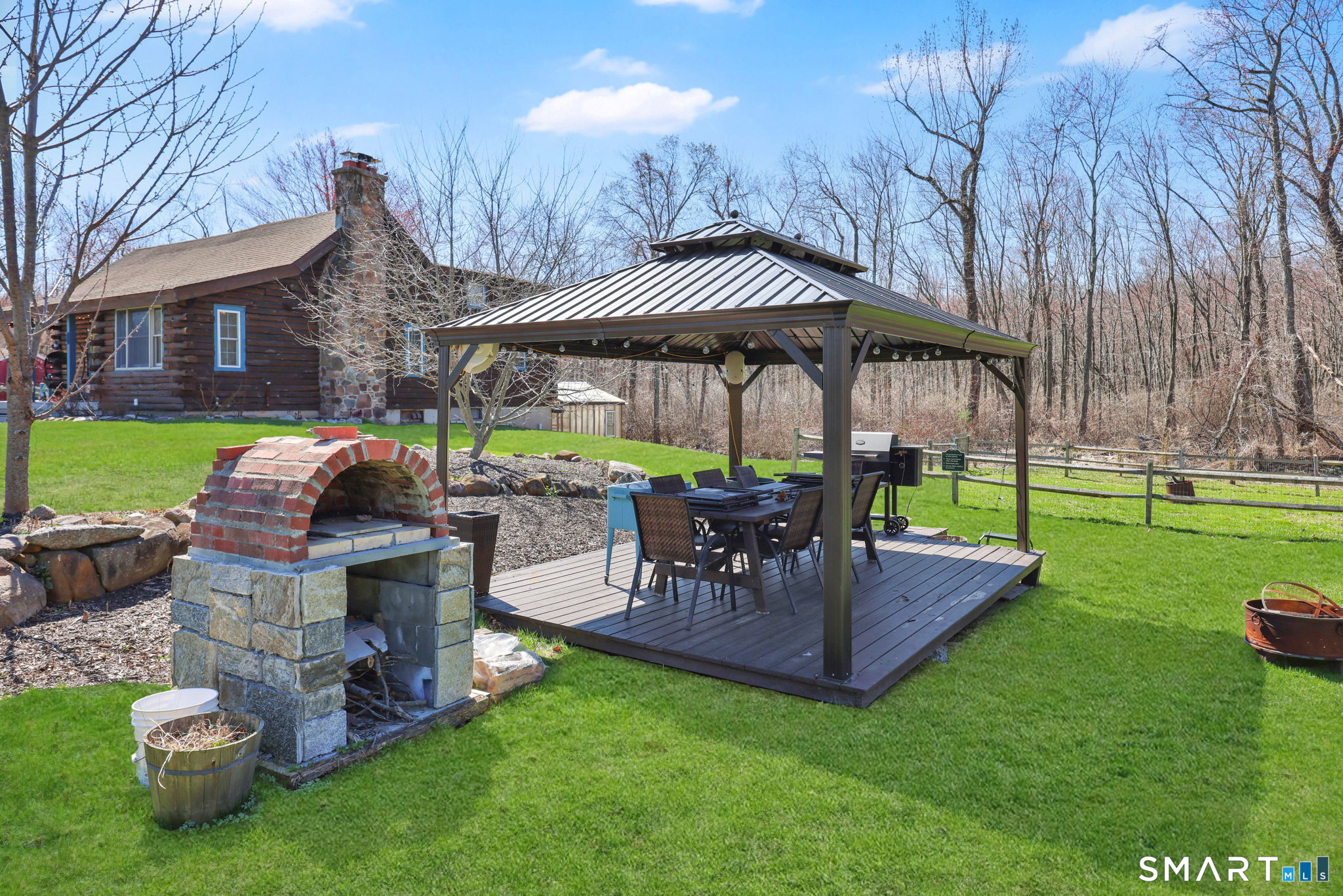 800 Gaylord Mountain Road Hamden, CT 06518 - Photo 34 of 40 a patio table and chairs with the garden
