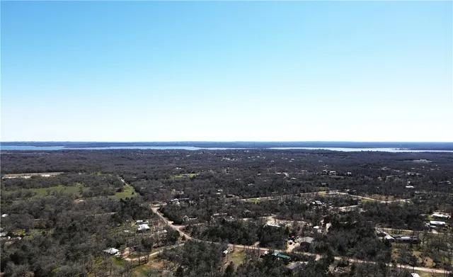 an aerial view of residential houses with city view