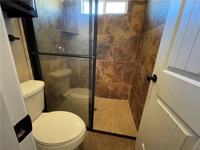 a white toilet sitting next to a bathroom sink