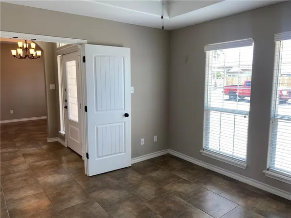 a view of an empty room with a window