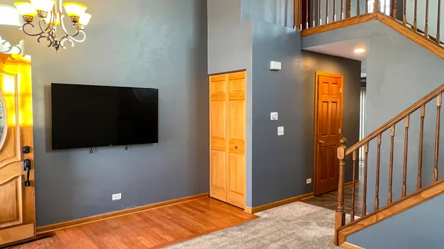 a view of a livingroom with wooden floor and windows