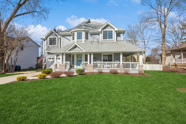 a front view of a house with swimming pool having outdoor seating