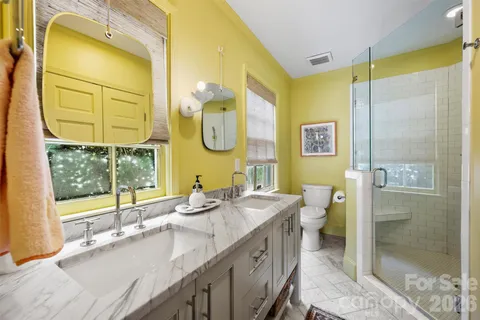a bathroom with a double vanity sink and a mirror