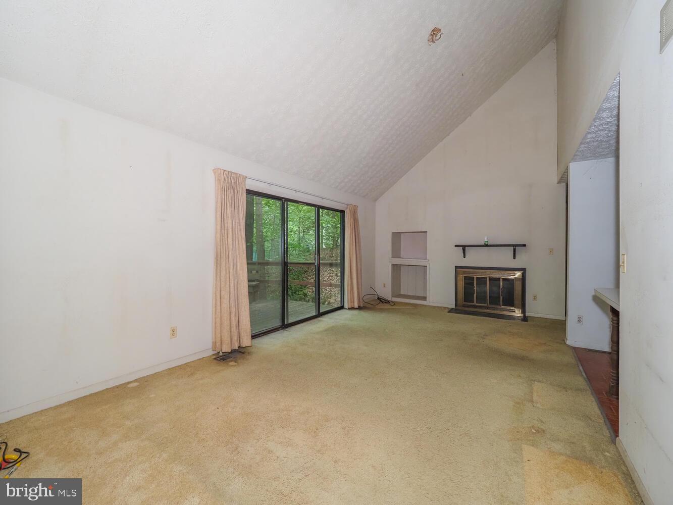 524 Ridge Road Annapolis, MD 21401 - Photo 17 of 58 a view of an empty room with a fireplace and a large window
