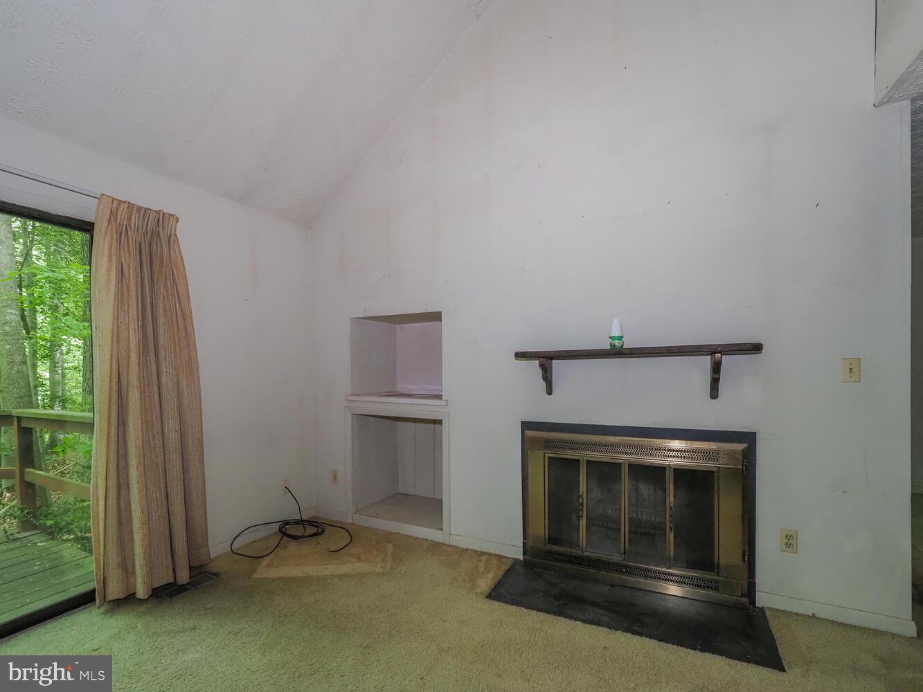 524 Ridge Road Annapolis, MD 21401 - Photo 19 of 58 a view of an empty room with a fireplace and a window