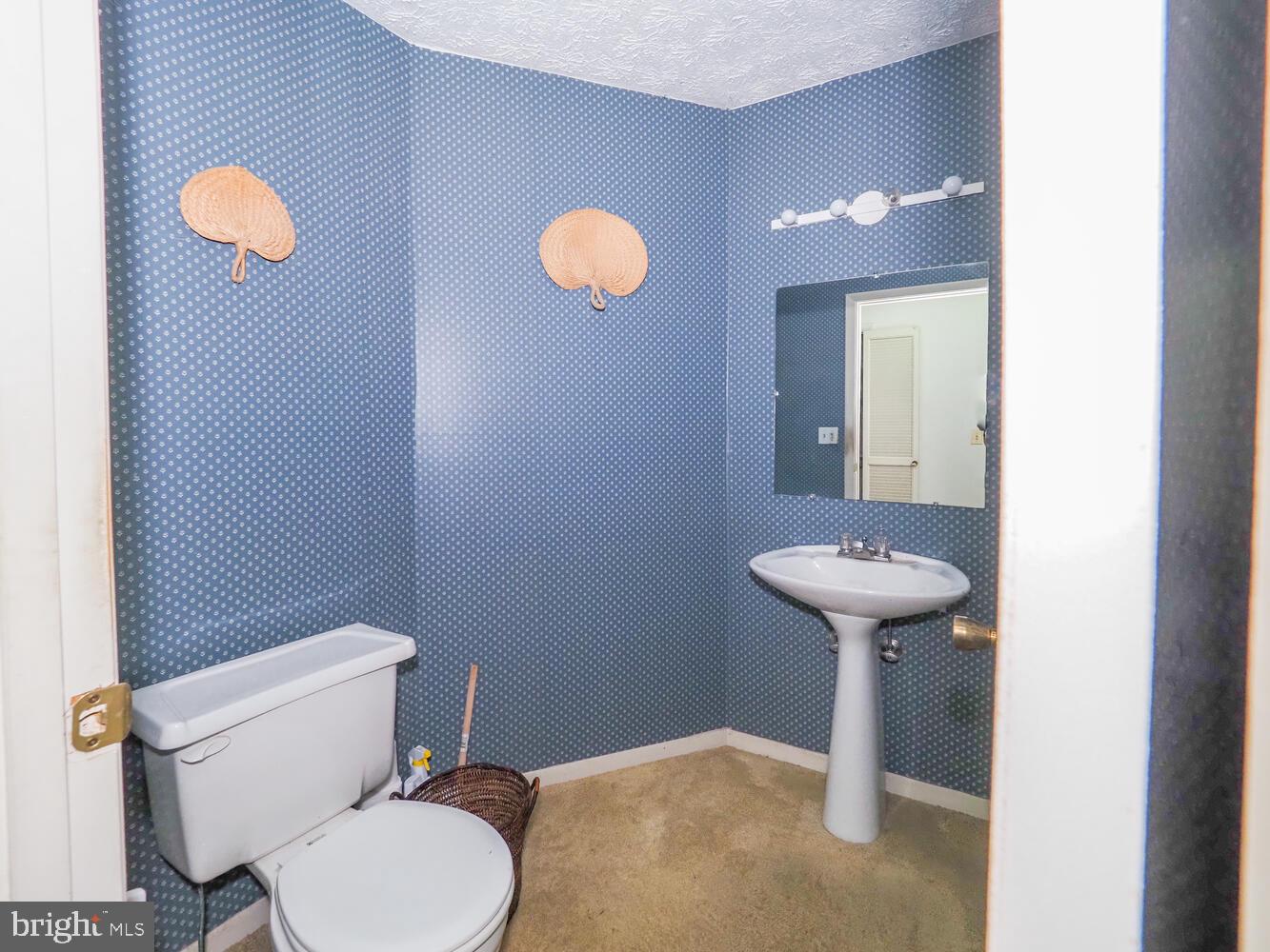 524 Ridge Road Annapolis, MD 21401 - Photo 42 of 58 a bathroom with a sink a toilet and mirror