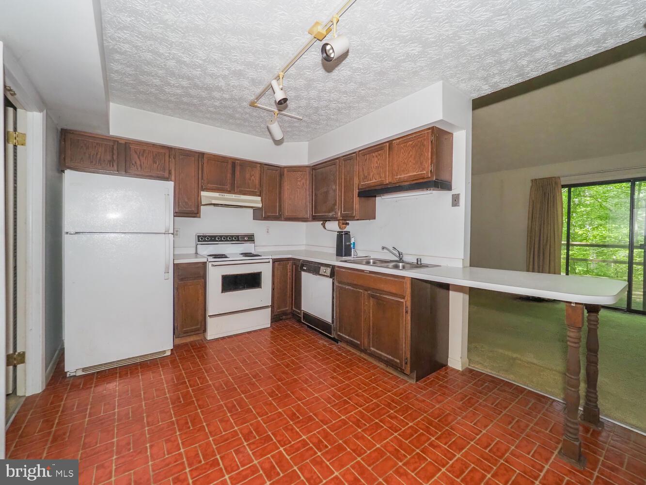 524 Ridge Road Annapolis, MD 21401 - Photo 6 of 58 a kitchen with stainless steel appliances granite countertop a refrigerator a sink dishwasher a stove with white cabinets and wooden floor