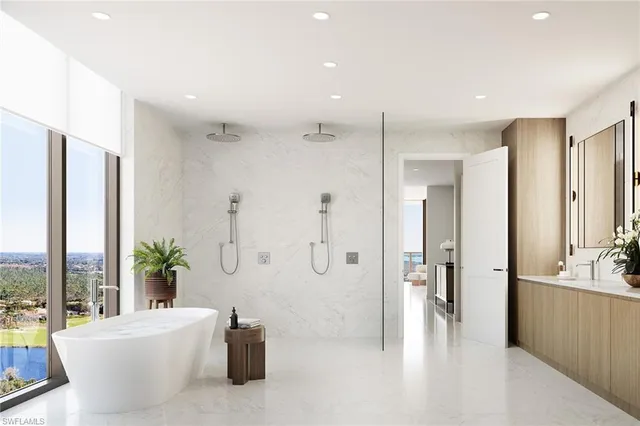 a spacious bathroom with a tub shower and a sink