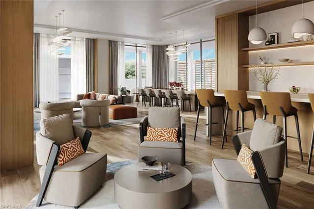 a living room with furniture and floor to ceiling windows