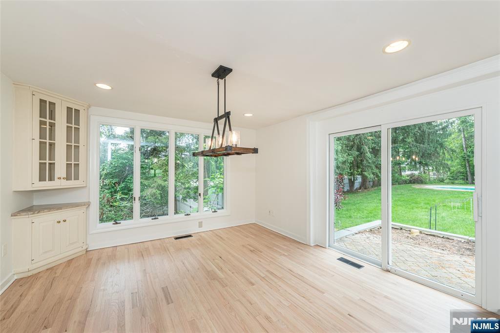 163 Sand Spring Road Morristown, NJ 07960 - Photo 7 of 39 a view of an empty room with wooden floor and a window
