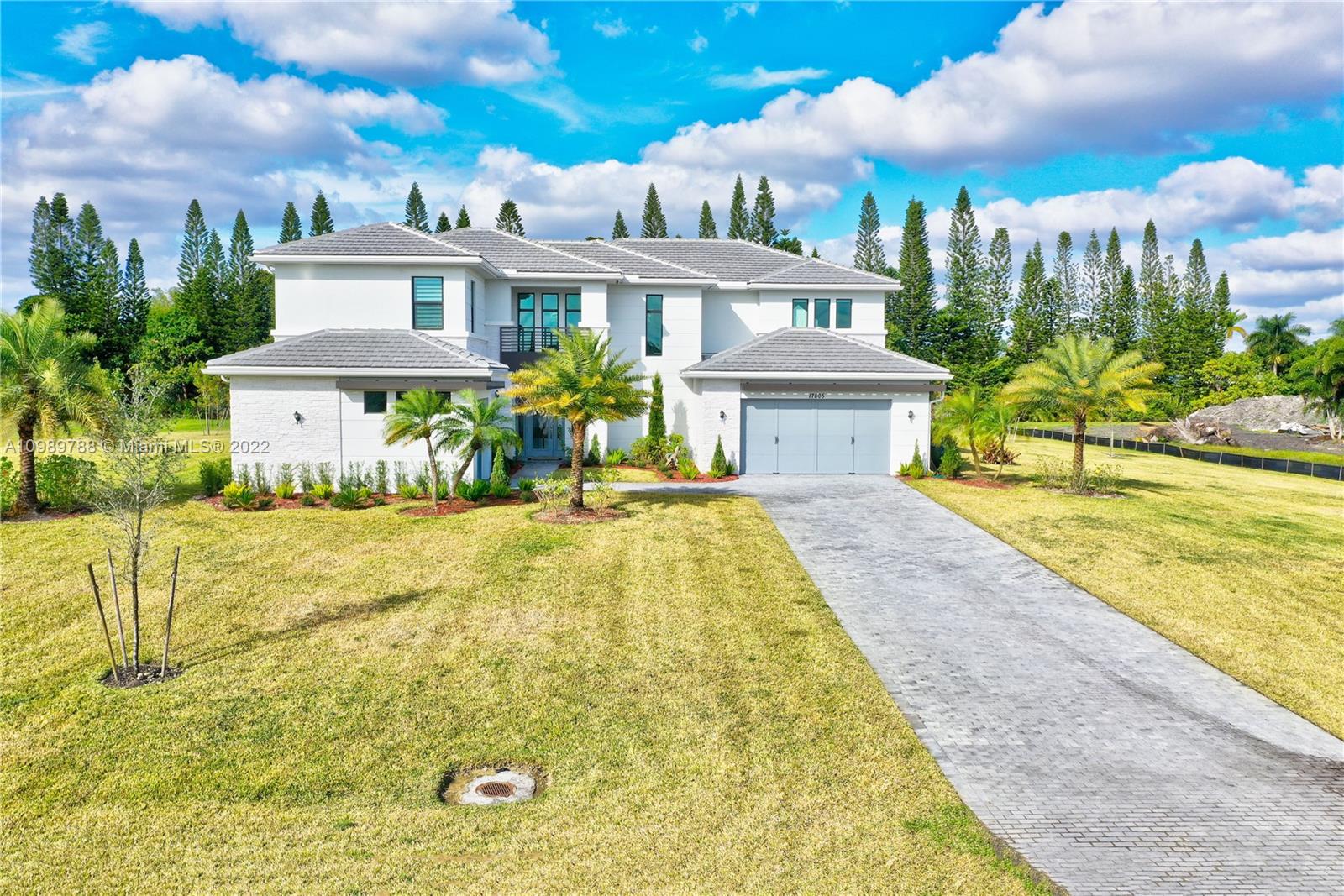 a view of a house with swimming pool and sitting area