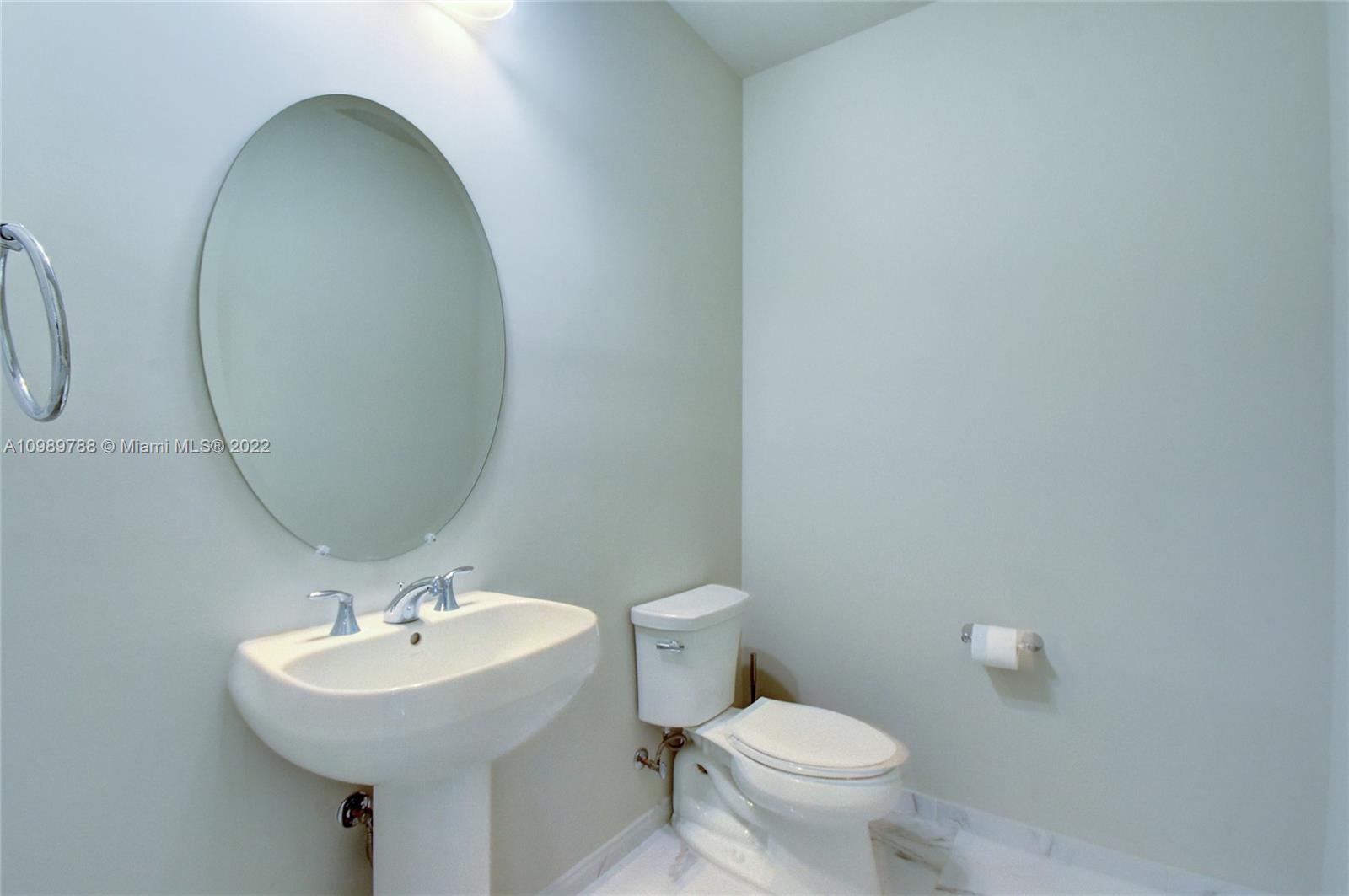 17805 Rolling Oaks Estates Dr Ranches Southwest Ranches, FL 33331 - Photo 15 of 49 a bathroom with a toilet a sink and a mirror