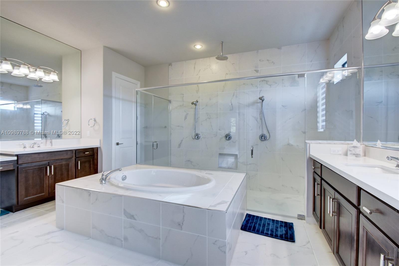 17805 Rolling Oaks Estates Dr Ranches Southwest Ranches, FL 33331 - Photo 20 of 49 a bathroom with a tub a sink a mirror and a shower