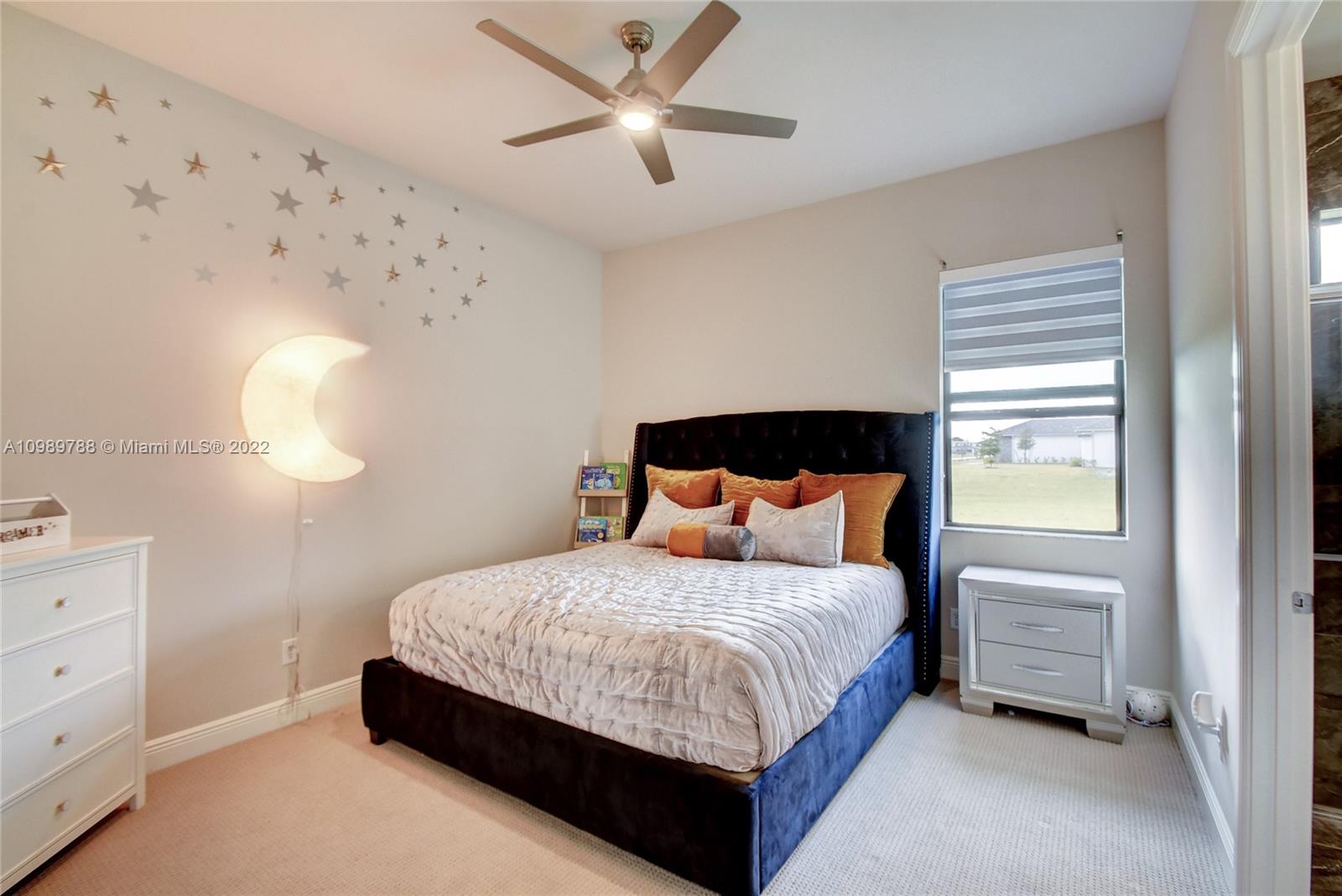 17805 Rolling Oaks Estates Dr Ranches Southwest Ranches, FL 33331 - Photo 26 of 49 a bedroom with a bed chandelier and a window