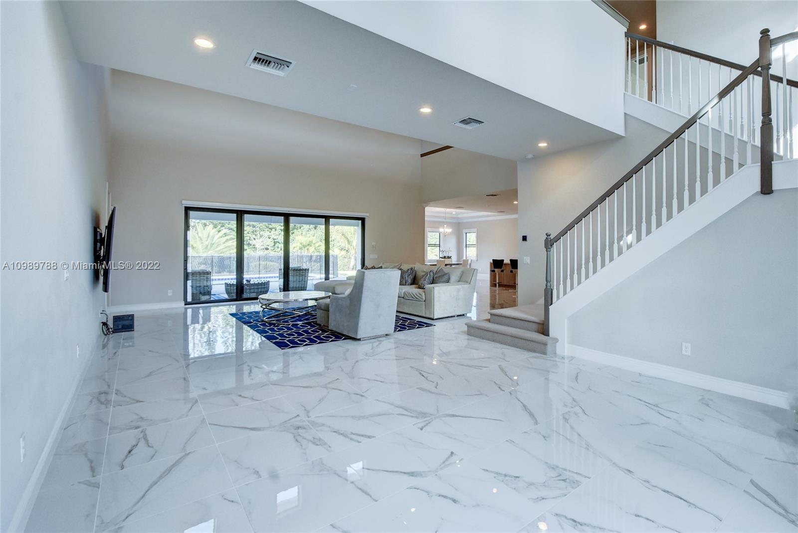 17805 Rolling Oaks Estates Dr Ranches Southwest Ranches, FL 33331 - Photo 3 of 49 a view of an entryway with floor to ceiling windows and dining room view