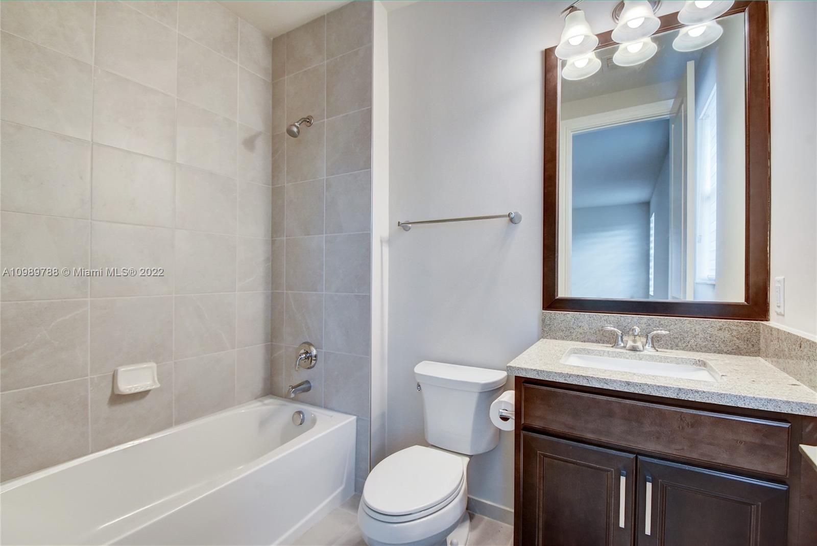 17805 Rolling Oaks Estates Dr Ranches Southwest Ranches, FL 33331 - Photo 35 of 49 a bathroom with a sink a toilet and shower