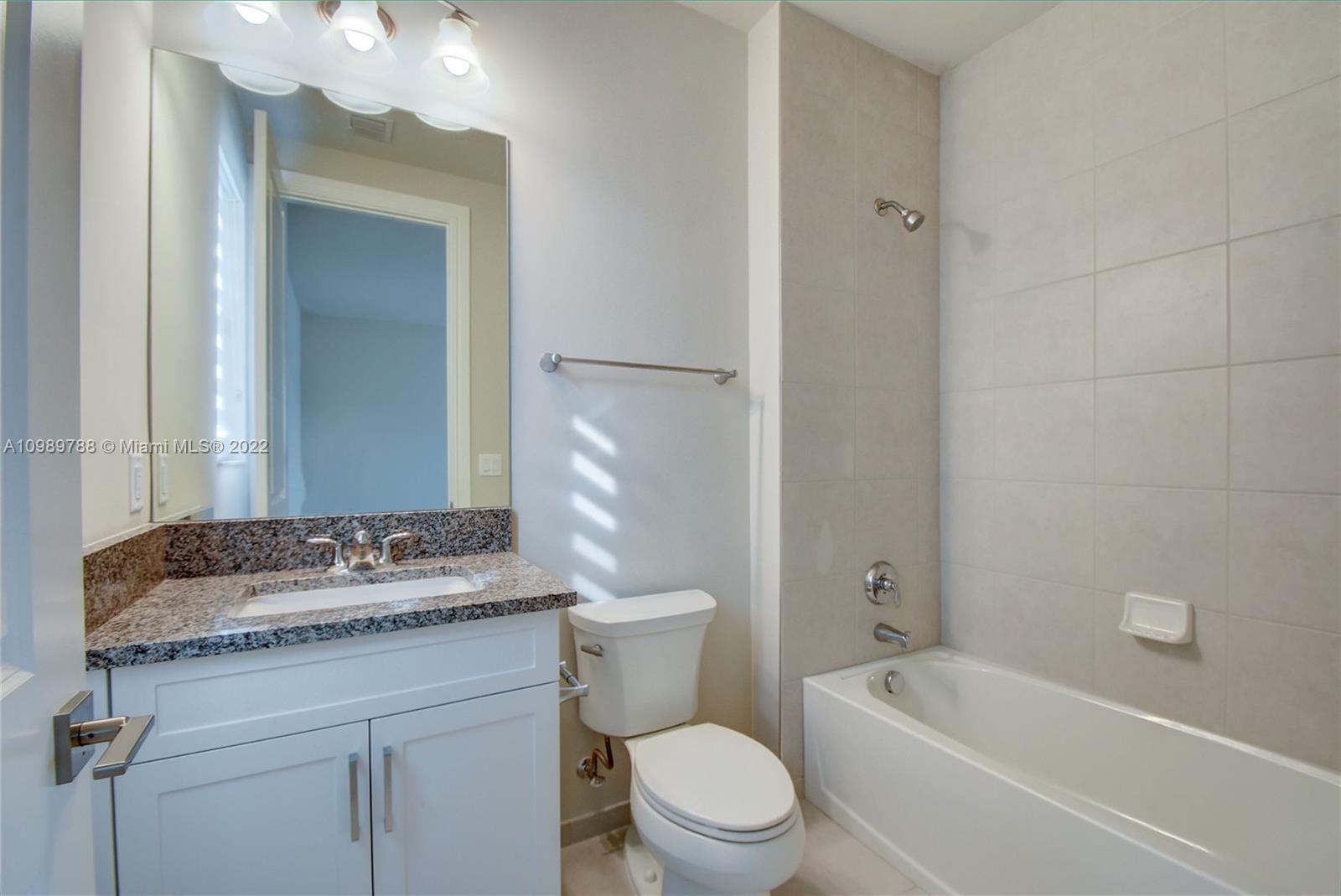 17805 Rolling Oaks Estates Dr Ranches Southwest Ranches, FL 33331 - Photo 37 of 49 a bathroom with a granite countertop toilet a sink and a bathtub