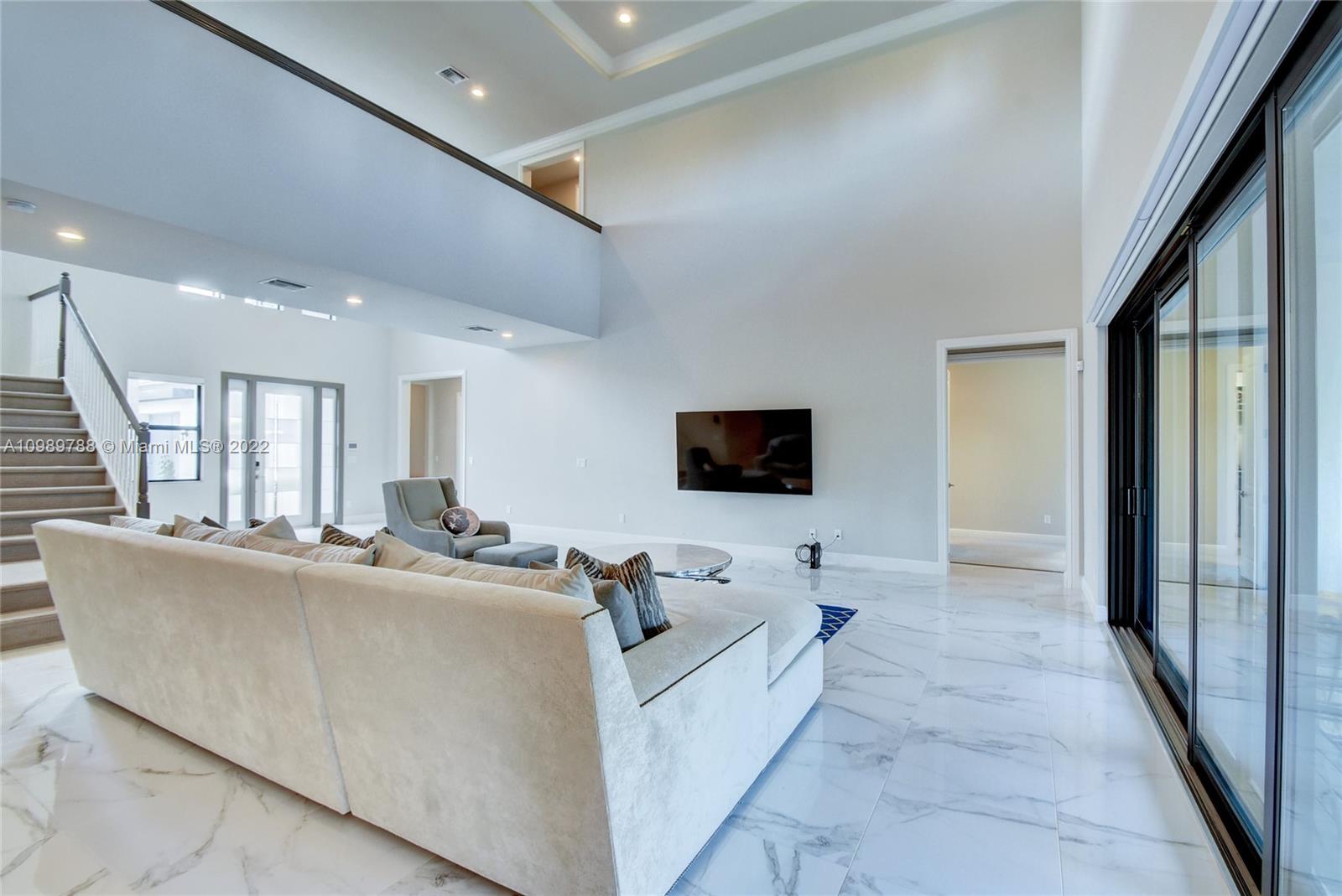 17805 Rolling Oaks Estates Dr Ranches Southwest Ranches, FL 33331 - Photo 5 of 49 a living room with furniture and a flat screen tv