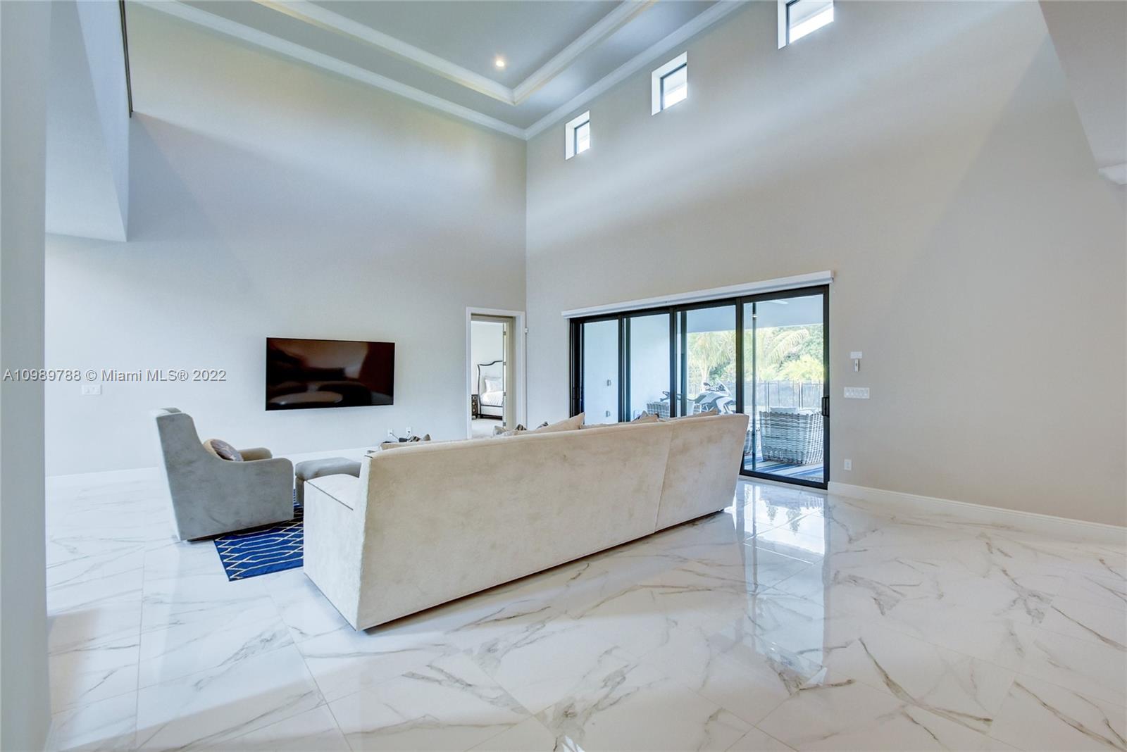 17805 Rolling Oaks Estates Dr Ranches Southwest Ranches, FL 33331 - Photo 6 of 49 a living room with furniture and a flat screen tv