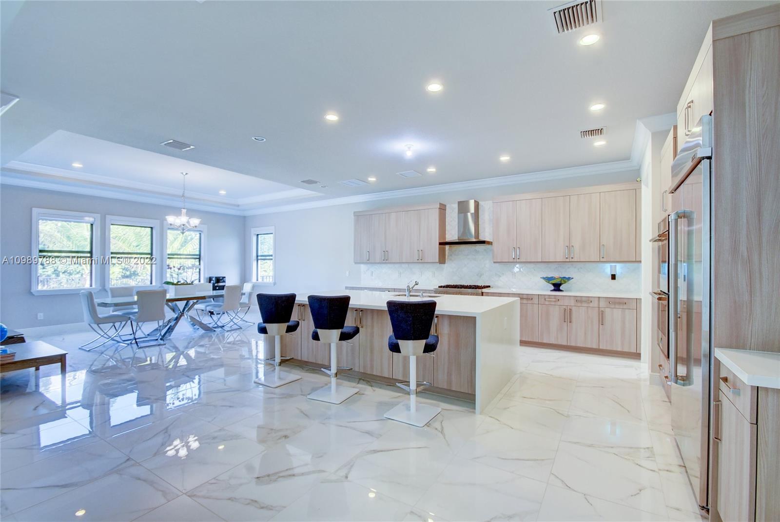 17805 Rolling Oaks Estates Dr Ranches Southwest Ranches, FL 33331 - Photo 7 of 49 a large white kitchen with lots of counter space and windows