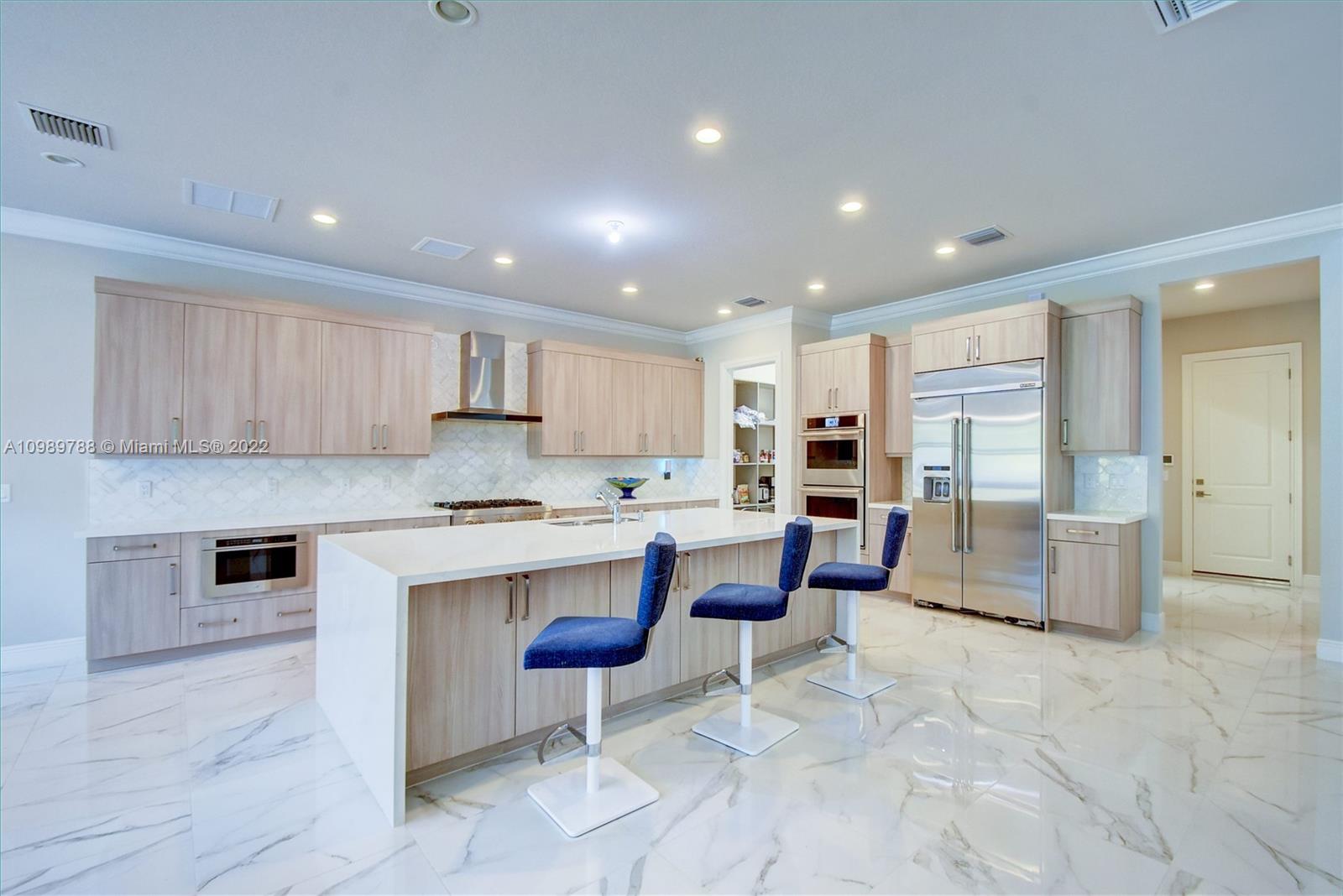 17805 Rolling Oaks Estates Dr Ranches Southwest Ranches, FL 33331 - Photo 8 of 49 a kitchen with stainless steel appliances granite countertop a stove top oven a sink dishwasher and a refrigerator