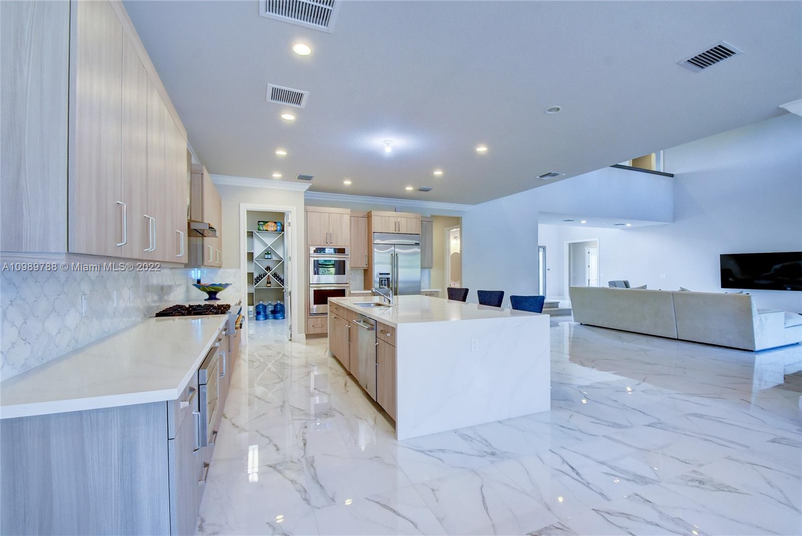 17805 Rolling Oaks Estates Dr Ranches Southwest Ranches, FL 33331 - Photo 9 of 49 a large white kitchen with a large counter top appliances and cabinets