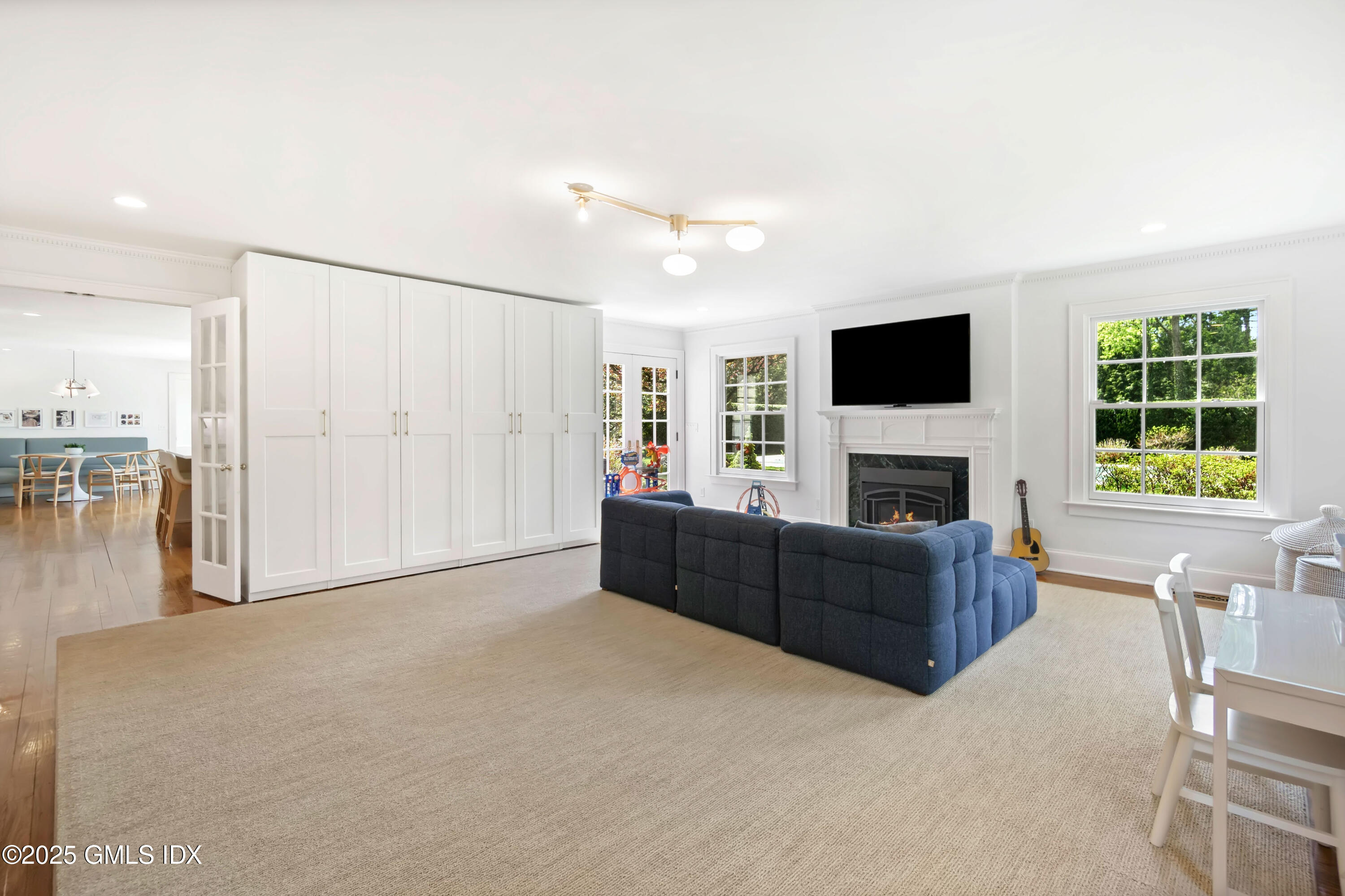 8 Woodside Road Greenwich, CT 06830 - Photo 2 of 10 a living room with furniture a fireplace and a flat screen tv