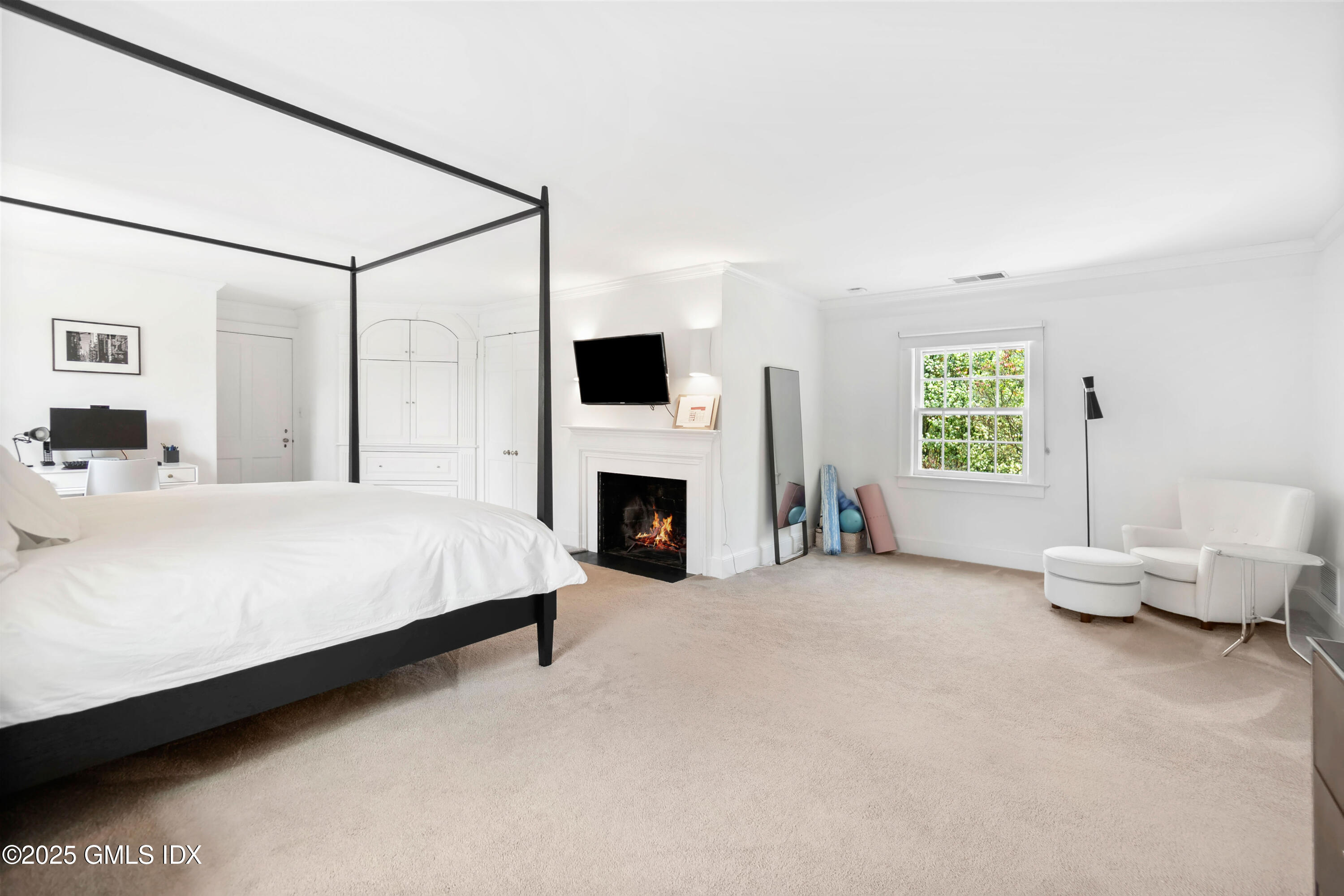 8 Woodside Road Greenwich, CT 06830 - Photo 4 of 10 a bed room with a bed and a fireplace