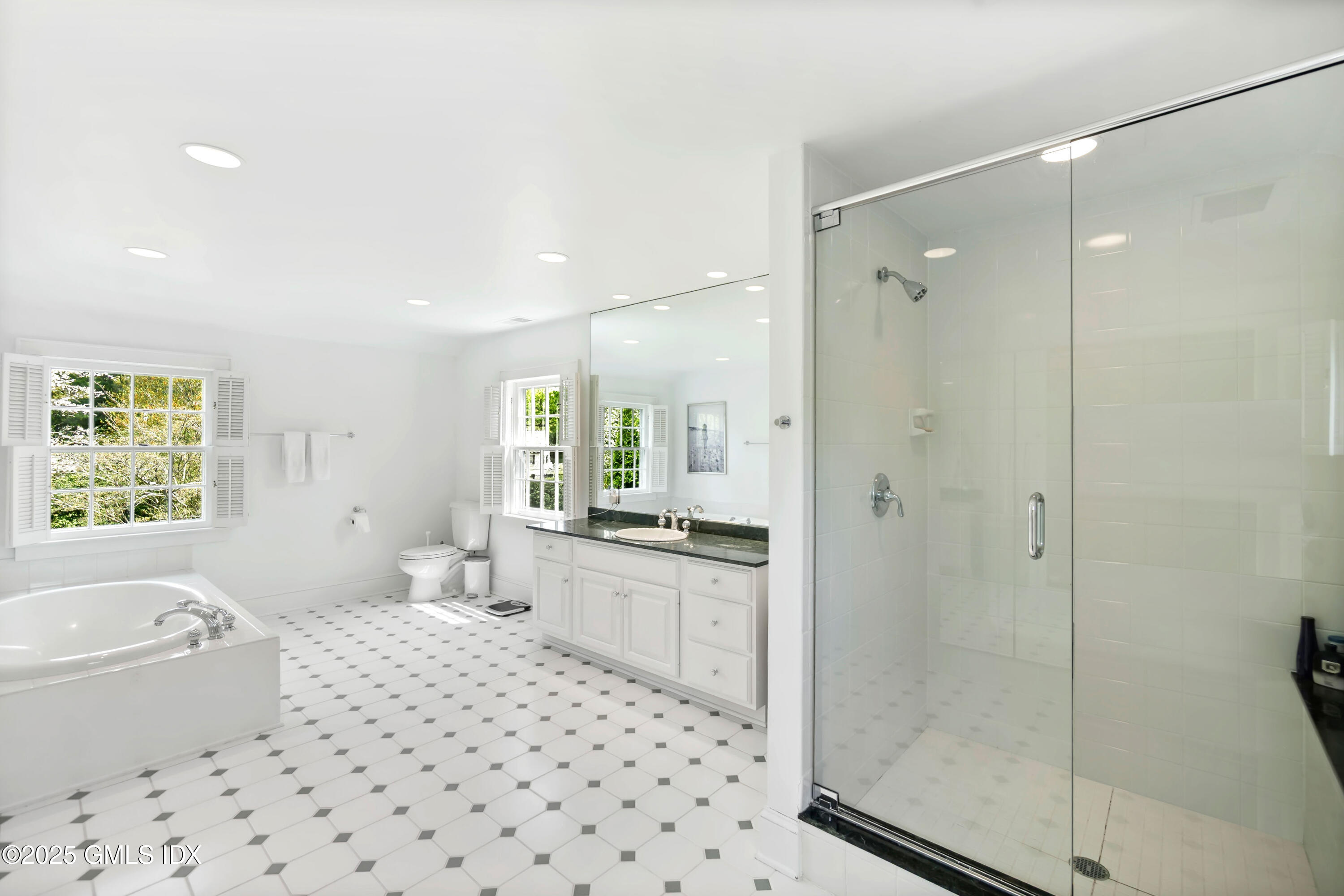 8 Woodside Road Greenwich, CT 06830 - Photo 5 of 10 a bathroom with a bathtub shower sink mirror and toilet