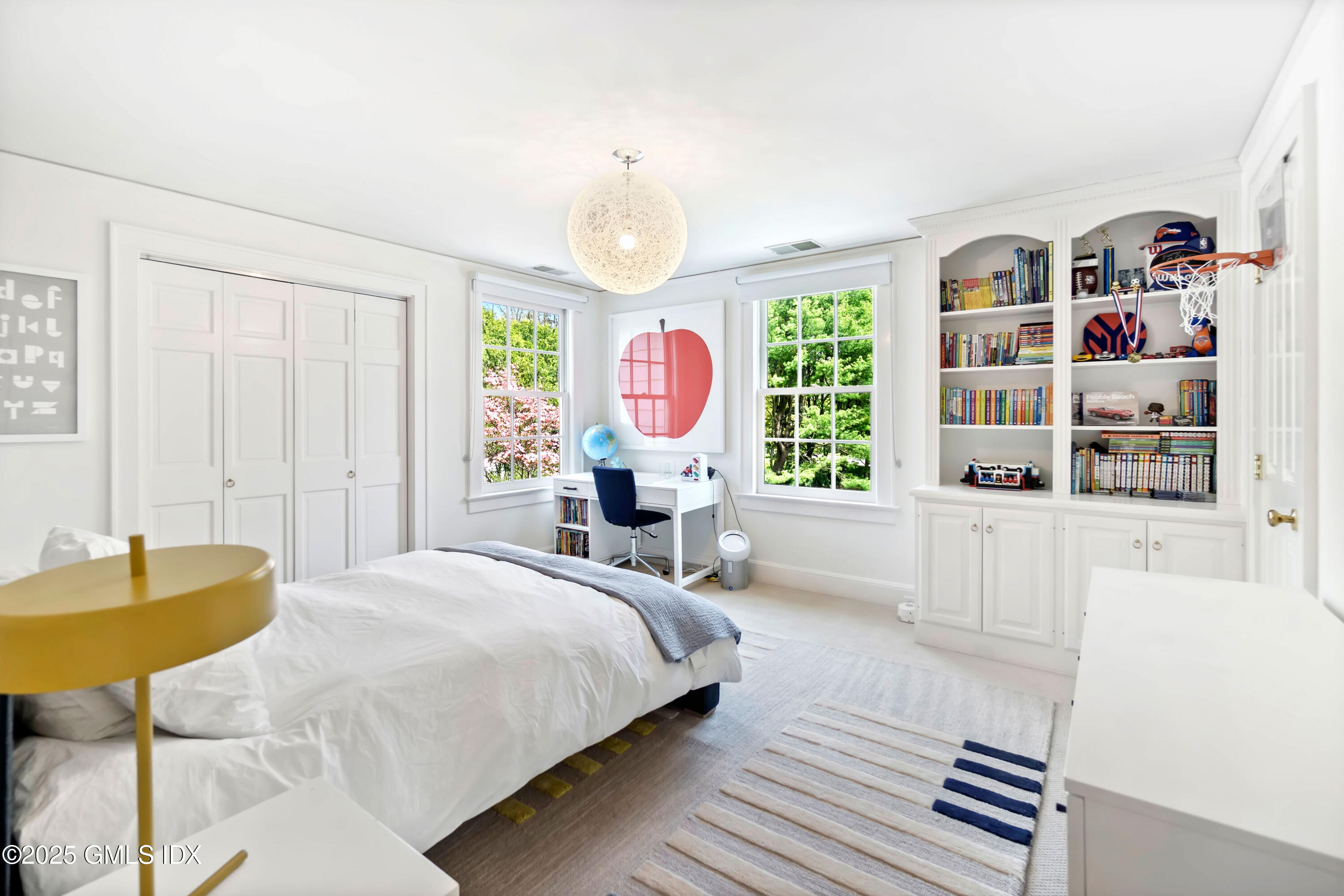 8 Woodside Road Greenwich, CT 06830 - Photo 6 of 10 a bed room with a bed and a book shelf