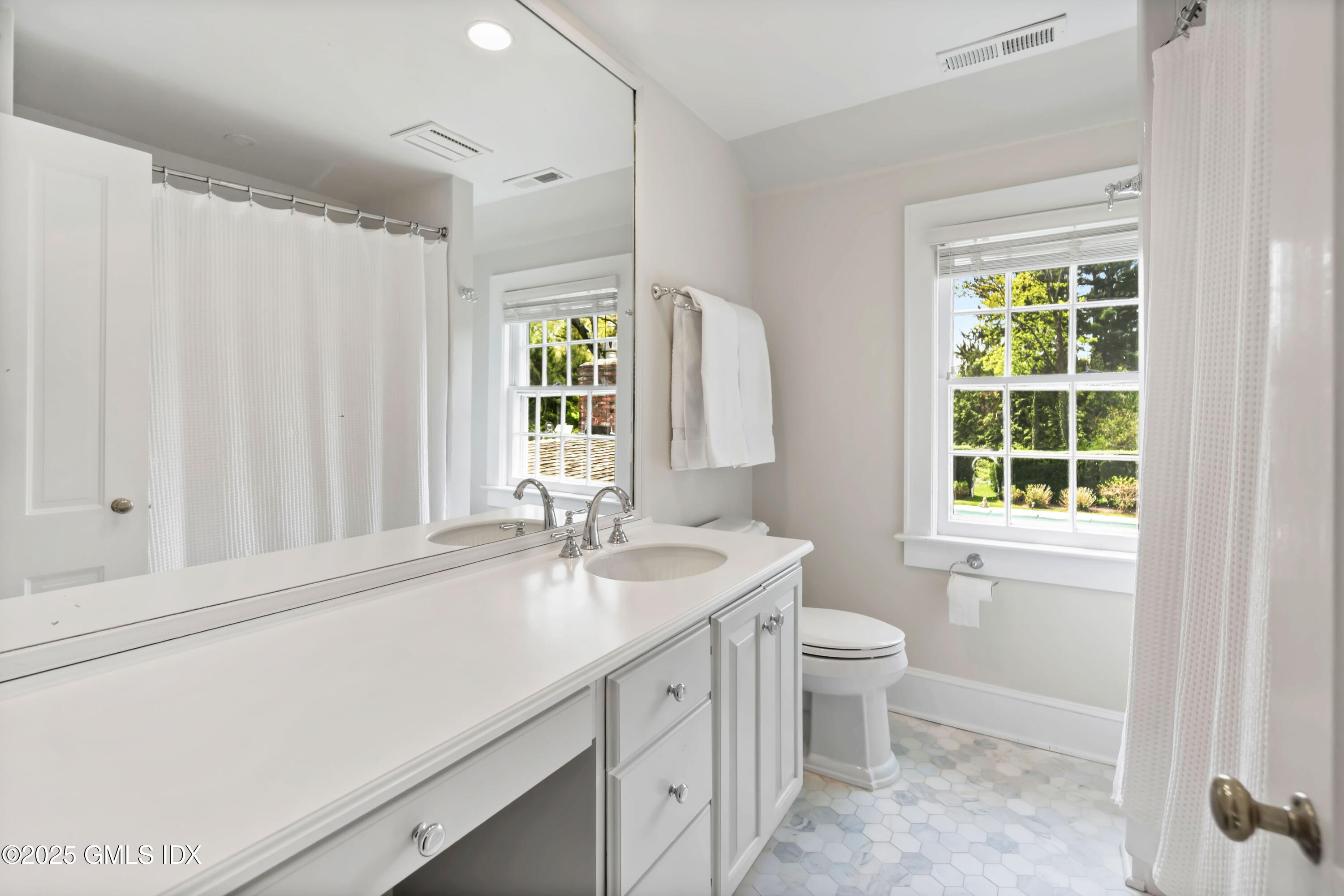 8 Woodside Road Greenwich, CT 06830 - Photo 10 of 10 a bathroom with a double vanity sink toilet and a window