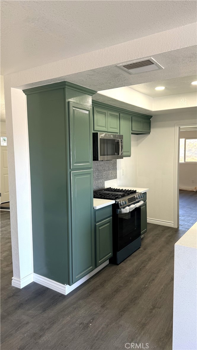 21145-21145 Kimes Lane Perris, CA 92570 - Photo 6 of 8 a large kitchen with stainless steel appliances granite countertop a stove and a refrigerator