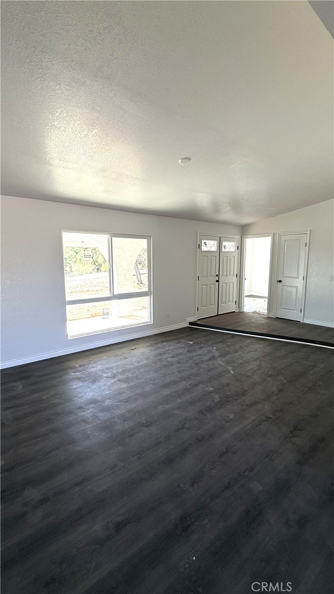 21145-21145 Kimes Lane Perris, CA 92570 - Photo 8 of 8 an empty room with wooden floor and windows