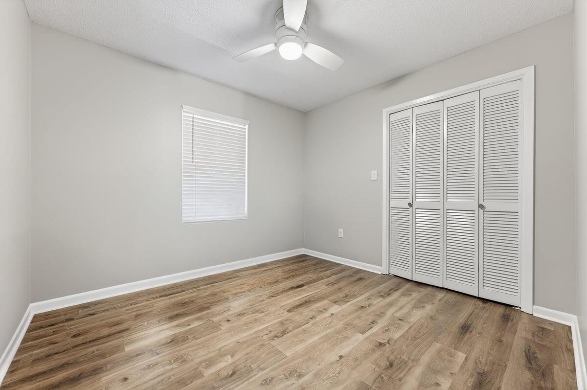 210 Shell Drive Crestview, FL 32536 - Photo 35 of 67 an empty room with wooden floor closet and windows