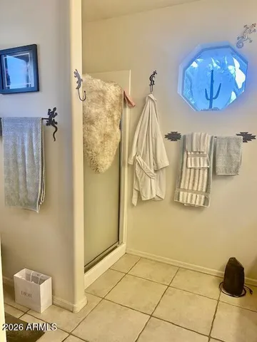 a bedroom with a bed window and a lamp