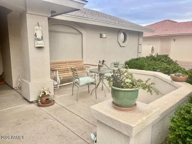 a view of a patio with table and chairs potted plants