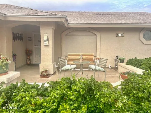 a view of a patio with table and chairs and potted plants