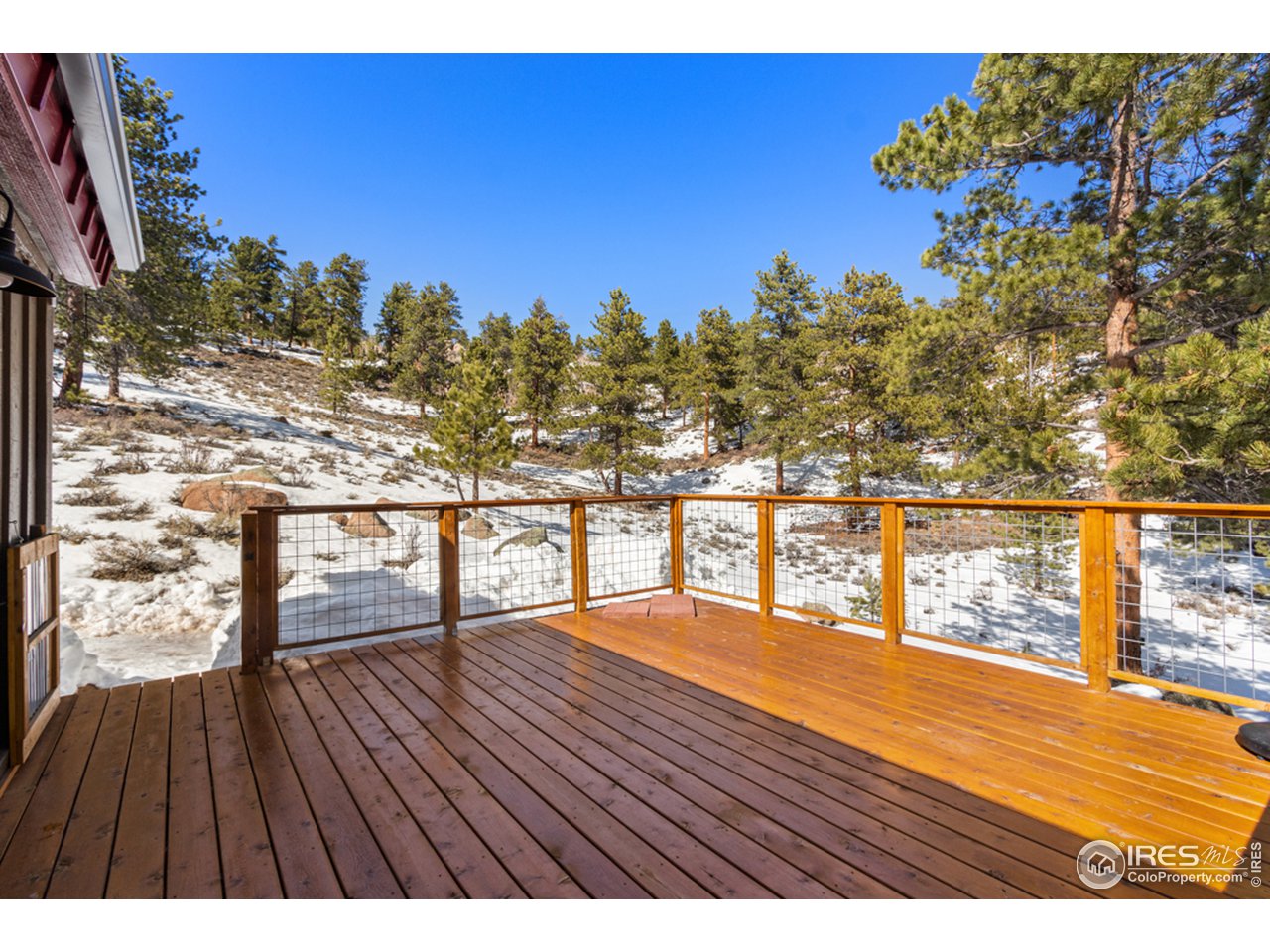 345 Caddo Road Red Feather Lakes, CO 80545 - Photo 11 of 40 from the kitchen you can access the spacious back deck for Bar-B-Q, entertaining, or relaxing