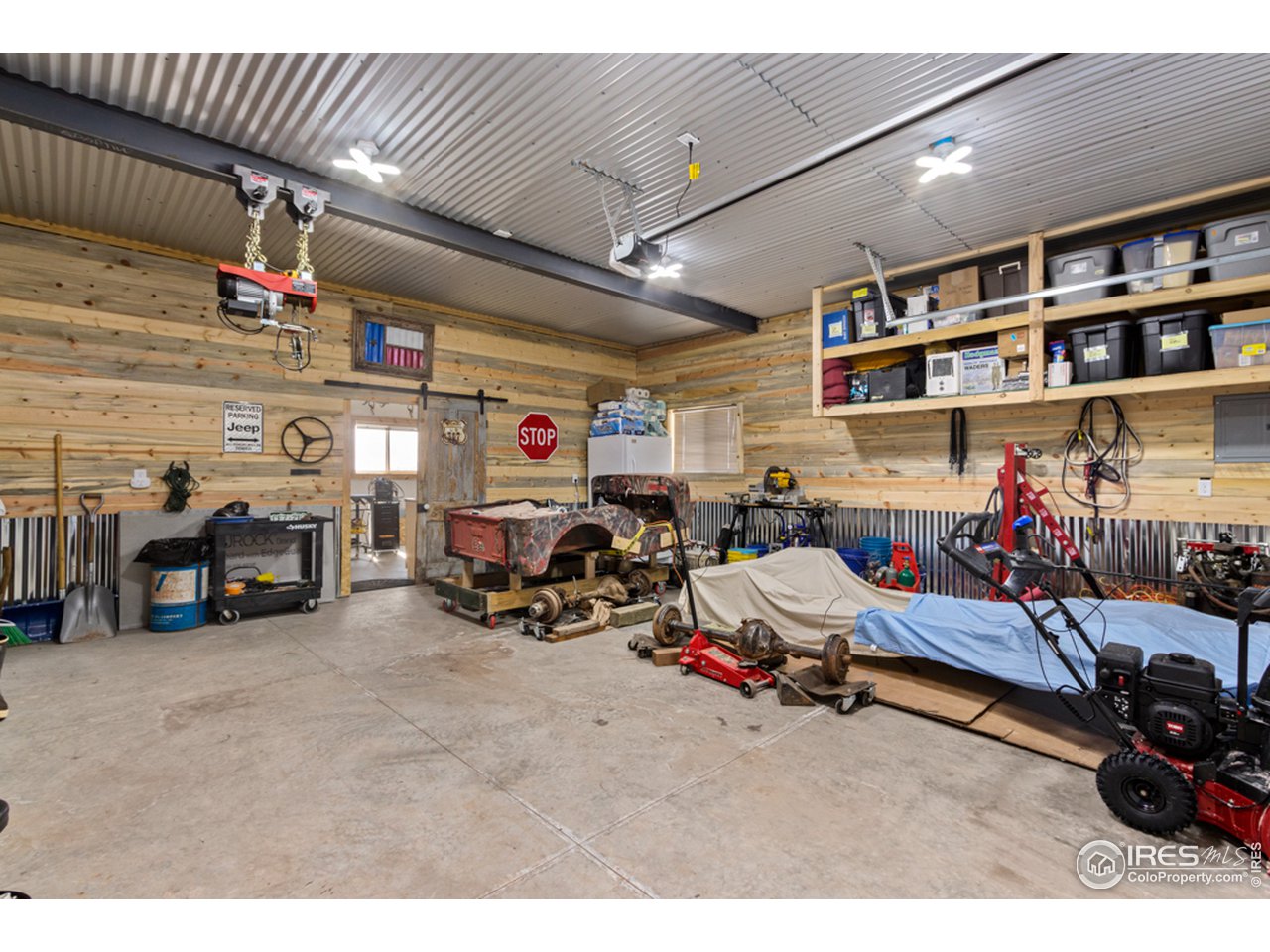 345 Caddo Road Red Feather Lakes, CO 80545 - Photo 26 of 40 sliding barn door in garage leads to "project room"