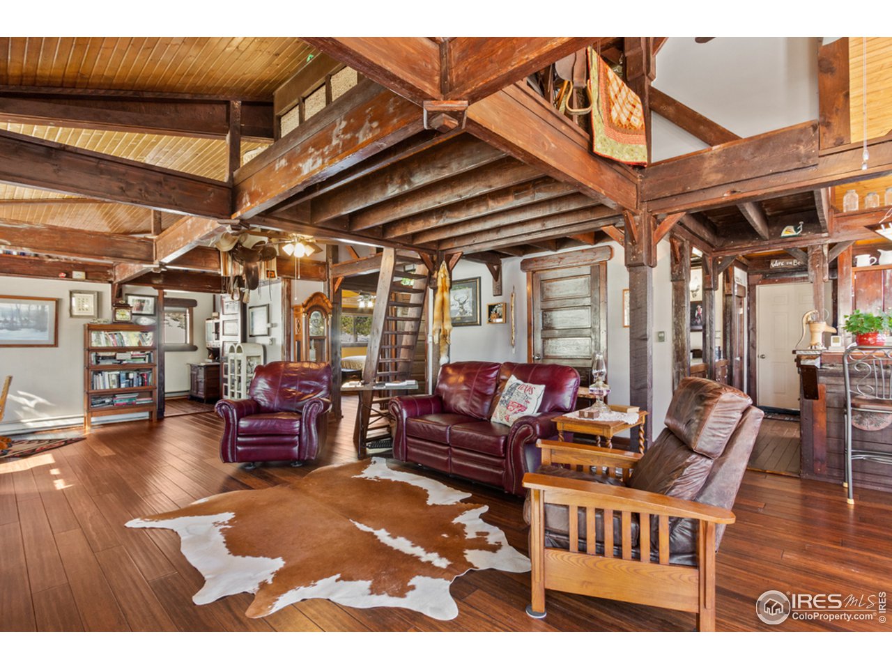 345 Caddo Road Red Feather Lakes, CO 80545 - Photo 7 of 40 reclaimed timber overhead-new bamboo flooring in the great room
