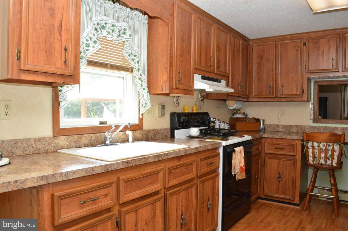 4948 Roller Road Manchester, MD 21102 - Photo 15 of 21 a kitchen with stainless steel appliances granite countertop a sink stove and cabinets