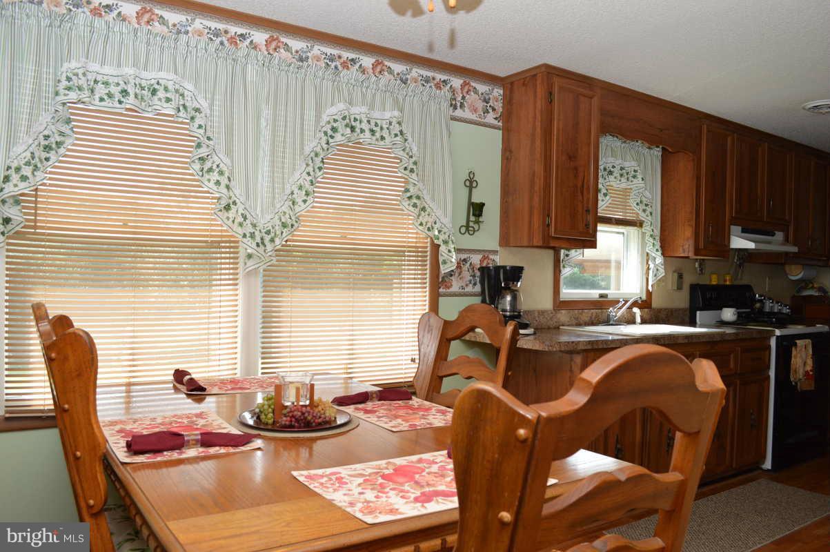 4948 Roller Road Manchester, MD 21102 - Photo 16 of 21 a view of a dining room with furniture window and outside view