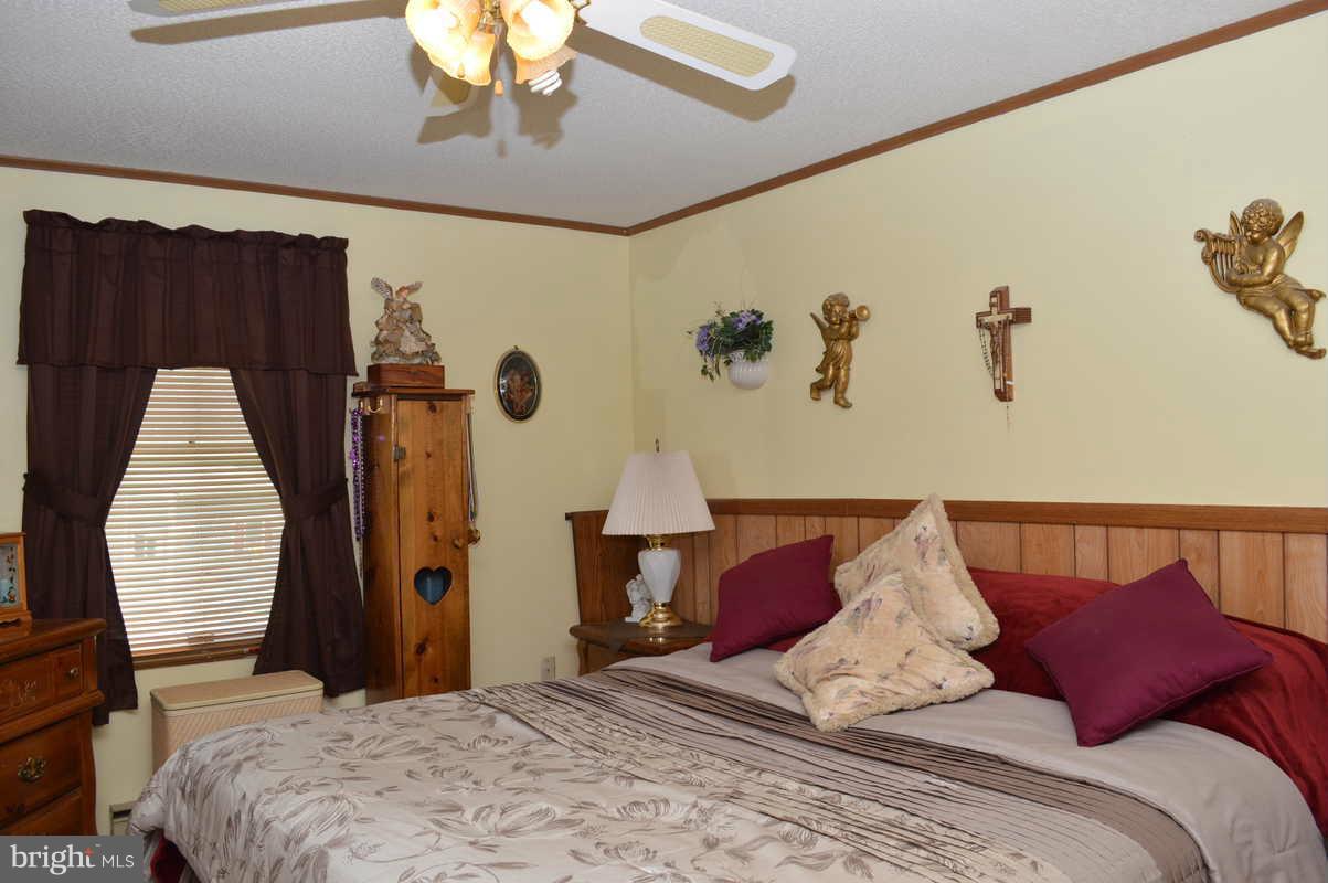 4948 Roller Road Manchester, MD 21102 - Photo 17 of 21 a bedroom with a bed and a painting on the wall