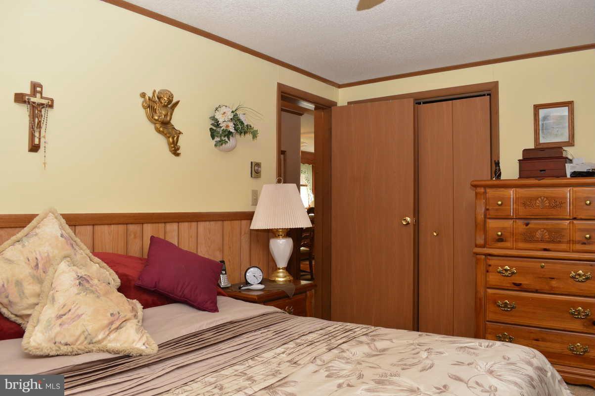4948 Roller Road Manchester, MD 21102 - Photo 18 of 21 a bedroom with a bed and a lamp on dresser
