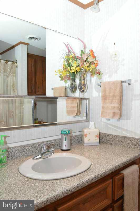 4948 Roller Road Manchester, MD 21102 - Photo 21 of 21 a bathroom with a sink granite vanity and a mirror