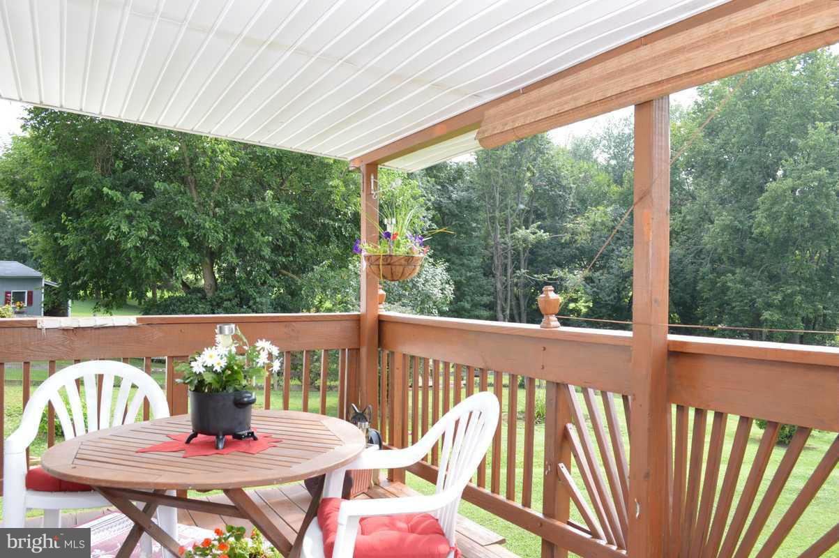 4948 Roller Road Manchester, MD 21102 - Photo 8 of 21 a view of a patio with a table chairs and a table