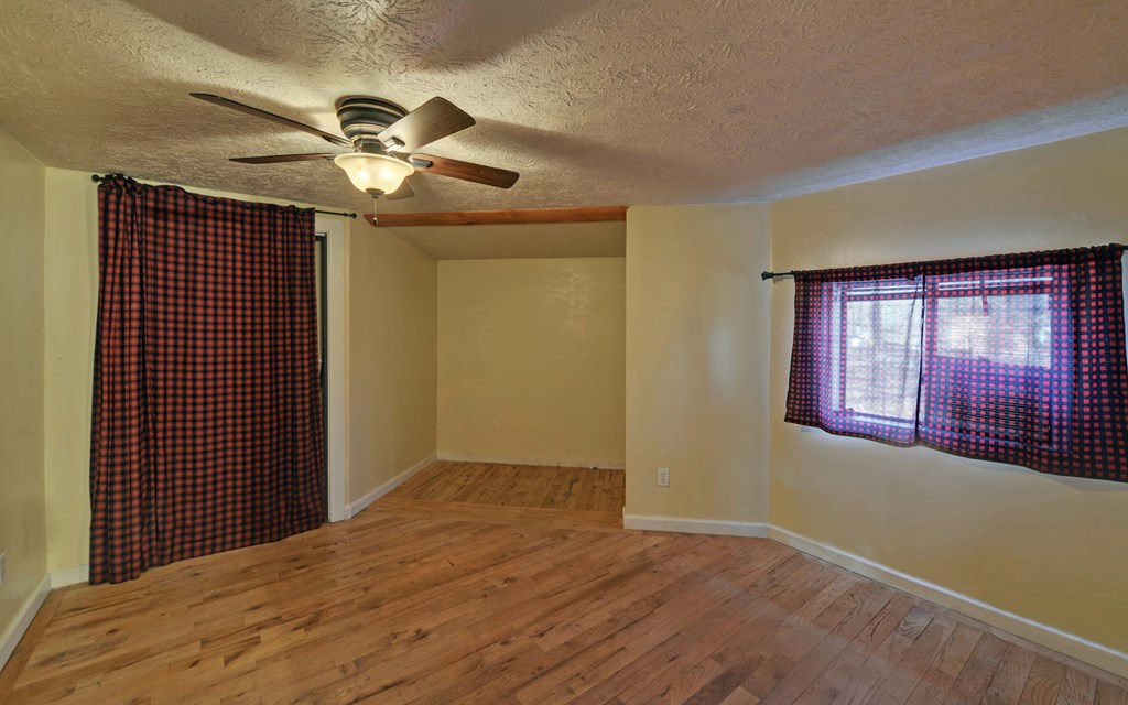 15 Trails End Road Blue Ridge, GA 30513 - Photo 12 of 46 a view of empty room with window and ceiling fan