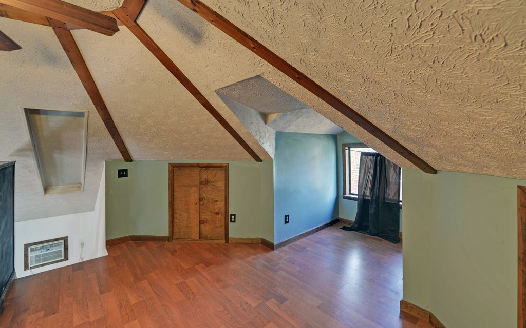 15 Trails End Road Blue Ridge, GA 30513 - Photo 17 of 46 a view of an empty room with wooden floor and stairs
