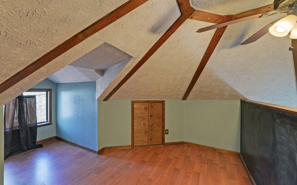 15 Trails End Road Blue Ridge, GA 30513 - Photo 18 of 46 a view of an empty room with wooden floor and stairs