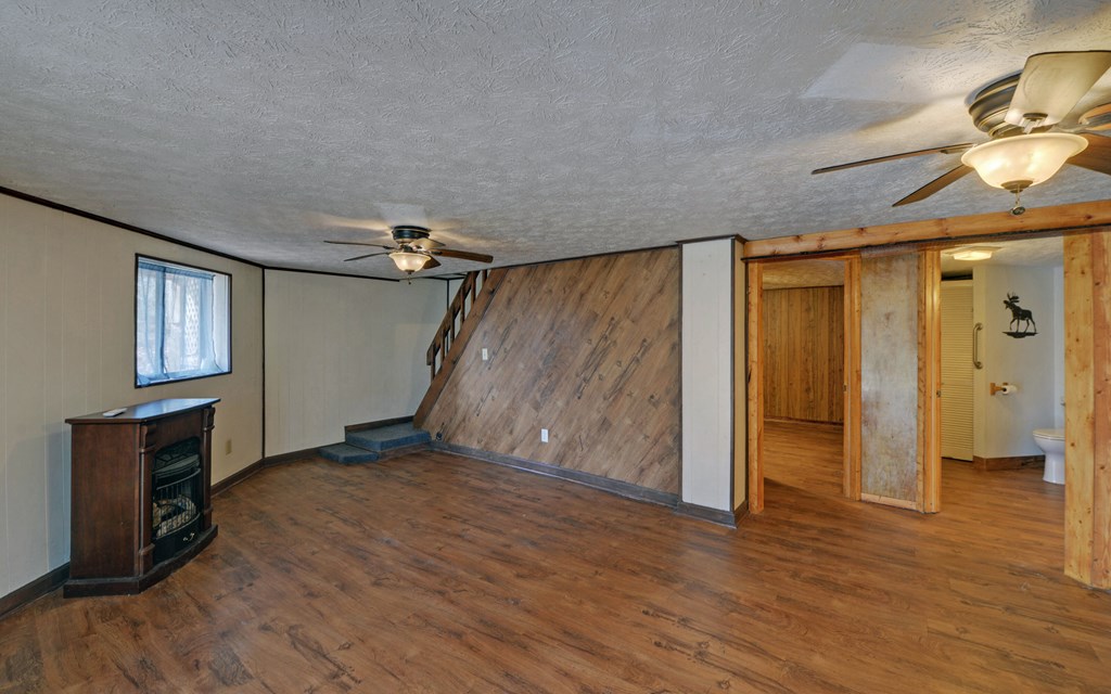 15 Trails End Road Blue Ridge, GA 30513 - Photo 19 of 46 a view of empty room with wooden floor and fan